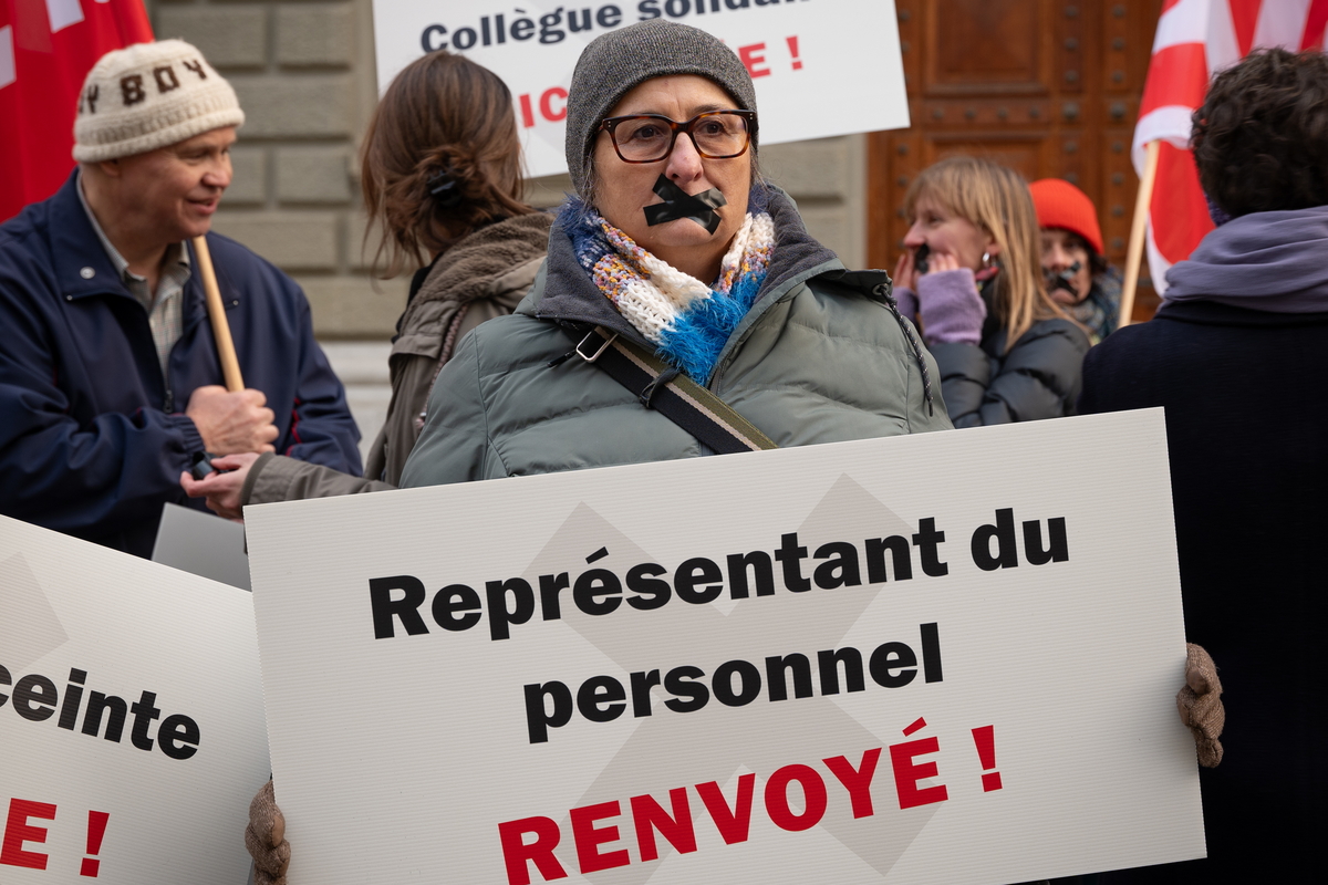 Attivista sindacale a una manifestazione con un cartello: 