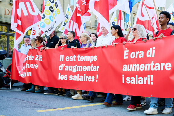 Striscione della manifestazione per i salari con la scritta: 