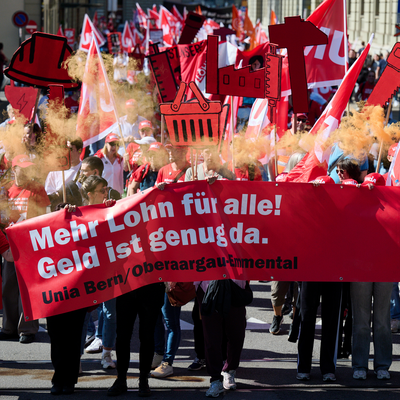 Grosses Transpi an Demo mit der Aufschrift: Mehr Lohn für alle! Geld ist genug da.