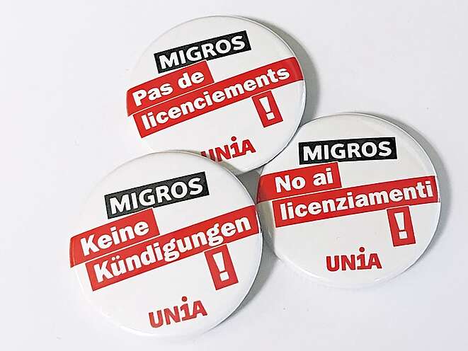 Badges, avec l'inscription «Migros. Pas de licenciements!»