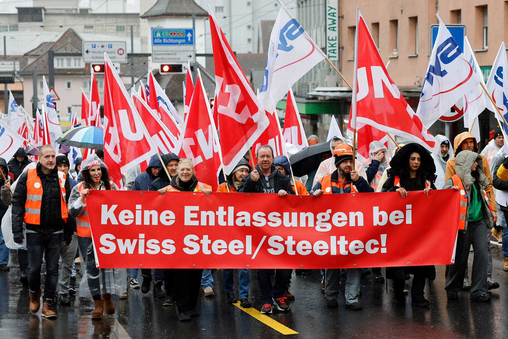 Beschäftigte von Steeltec an der Kundgebung im Regen mit Frontranspi: Keine Entlassungen bei Swiss Steel/Steeltec